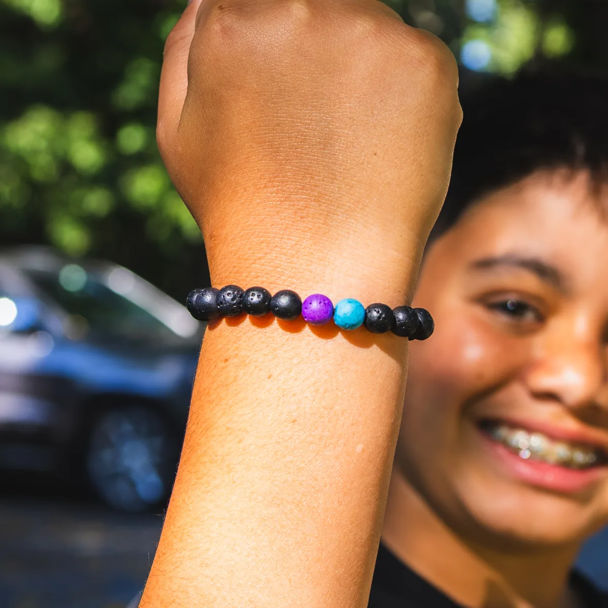Deven wearing a Volcanic Vibes bracelet with purple and turquoise accent beads